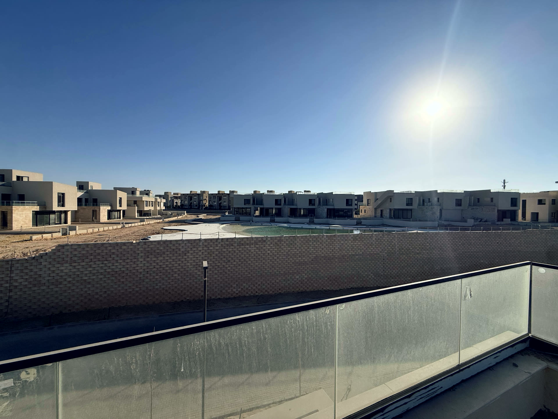 The rear view onto the lagoon and waterbodies, and the ground around the building